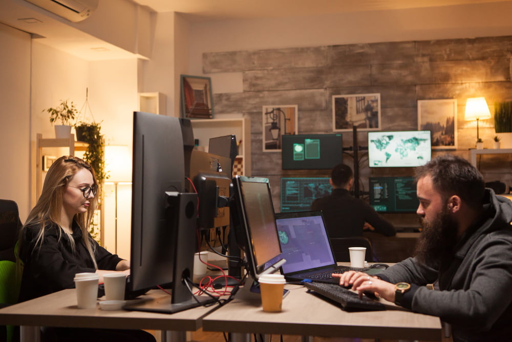 beautiful female hacker working together with cyber criminals hacker team