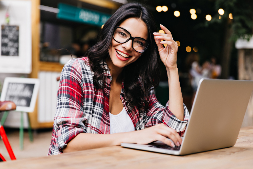 glamorous female freelancer enjoying morning working with laptop photo cheerful latin lady checkered shirt posing glasses