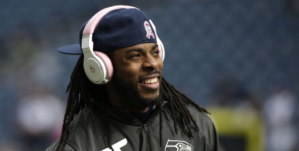 20 coisas que os viajantes levam na bagagem (eles deveriam levar na bagagem de mão) 13 feliz richard sherman usando fones de ouvido