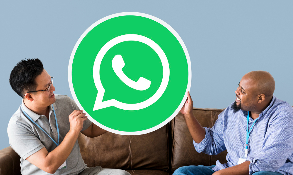 men showing whatsapp messenger icon