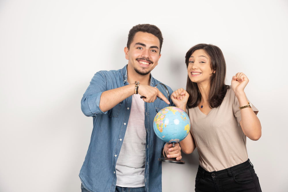 man woman posing with globe white